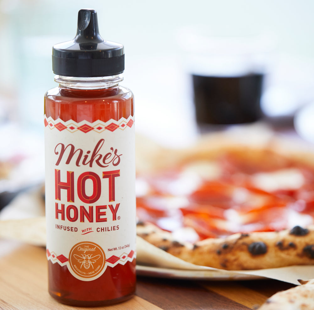 
            
                Load image into Gallery viewer, Mike&amp;#39;s Hot Honey spicy honey squeeze bottle infused with chilies
            
        